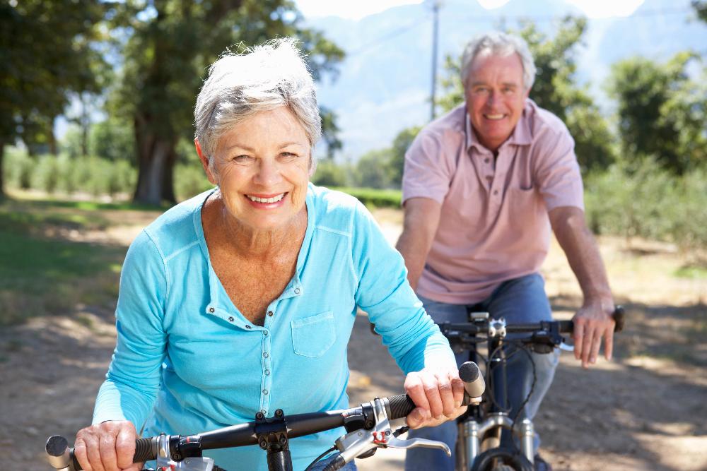 older couple riding bikes | dental crowns eagan mn