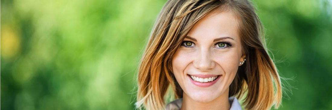 Woman with veneers smiling at Rahn Park in Eagan MN