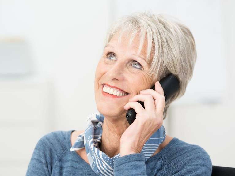 older woman on telephone | dentist near me