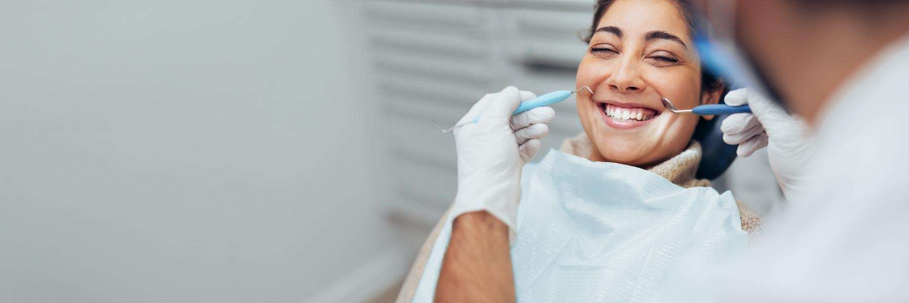 A woman seated comfortably on a dental chair