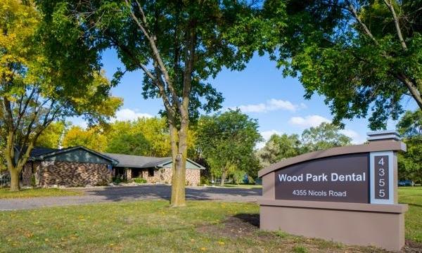 Exterior of Wood Park Dental building & entrance sign in 55122